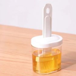 Plastic oil container with brush